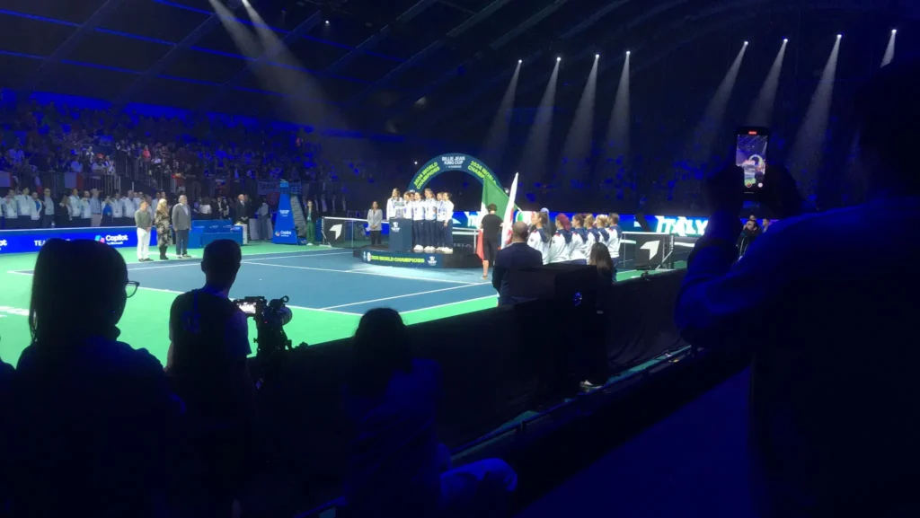 Stage setup with professional lights and sound system at the Billie Jean King Cup during a ceremony with teams and officials