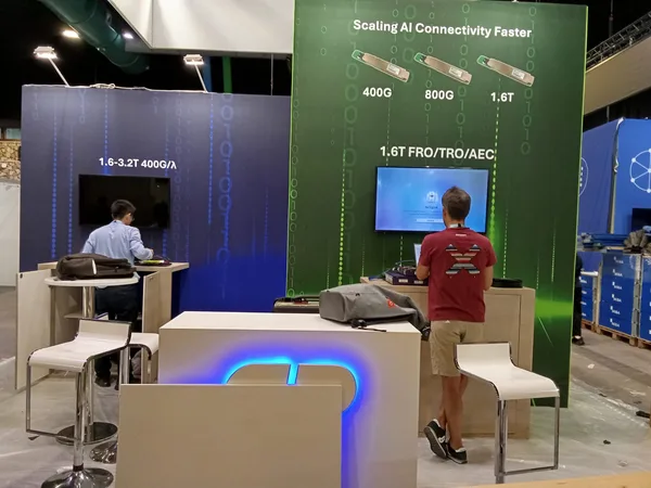 Exhibitors connecting laptops to their stand screens at ECOC 2026